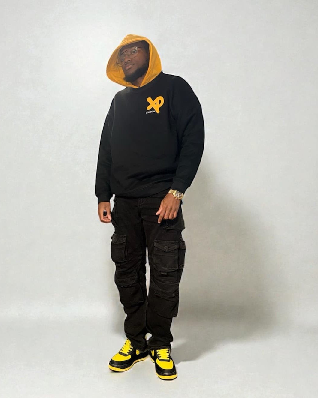 Black XP London sweatshirt with yellow XP logo worn by male model.