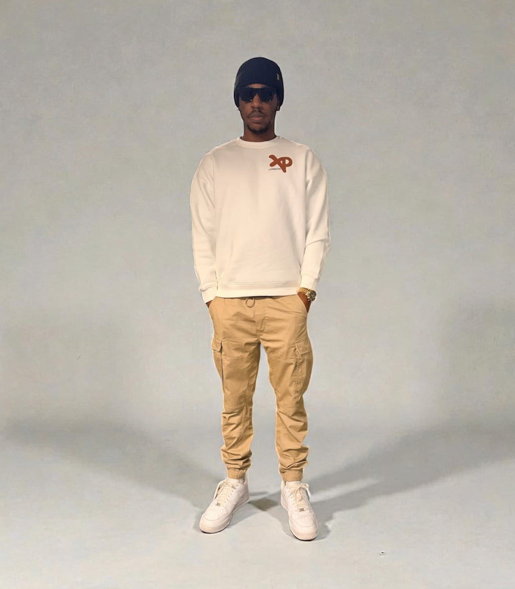 Front view of model wearing white XP London sweatshirt with brown logo